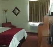 Bedroom 4 All American Inn and Suites