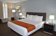 Bedroom 7 Days Inn & Suites by Wyndham Orlando Airport