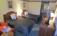 Bedroom 4 Travel Inn & Suites