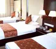 Bedroom 2 Qingdao Chengyang Qiulin Hotel