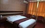 Kamar Tidur 5 Huayun Business Hotel
