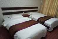 Kamar Tidur Huayun Business Hotel