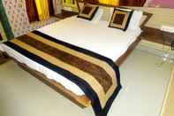 Bedroom Hotel Raj Palace by Sky Stays