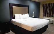 Bedroom 5 Woodridge Inn and Suites