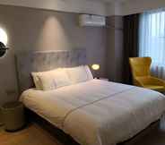 Bedroom 6 Magnotel Jining Jiaxiang, Zengzi Avenue Hotel