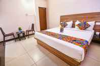 Bedroom FabHotel Radha Residency