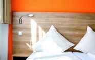 Kamar Tidur 2 Orange Hotel und Apartments