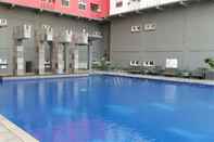 Swimming Pool Homey 1BR with Spacious Living Room and Sofa Bed Green Pramuka Apartment