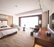 Phòng ngủ 7 Days Hotel & Suites by Wyndham Jiangsu Xinyi