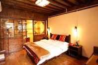 ห้องนอน Lijiang shuimuxiquan Inn