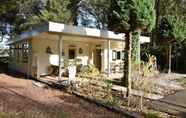 Exterior 4 A Detached Bungalow With Outdoor Fireplace, Covered Terrace and Pond in a Forest Plot