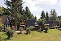 Exterior Wooden Chalet with Terrace near Swimming Lake