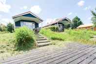 Exterior Beautiful Home With a Veranda and Jetty, Located Near a Pond