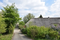Exterior Quaint Farmhouse near River in Oosterwijk