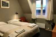 ห้องนอน Henriks Hotell