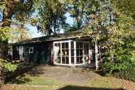 Exterior Cosy Forest Chalet in Voorthuizen With Indoor and Outdoor Pool