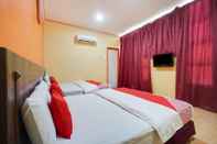 Kamar Tidur Bercam Times Inn Hotel