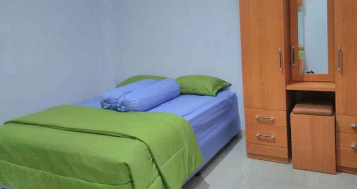 Bedroom Cozy Deluxe Room at Jl Kalimantan by Graha Pastika