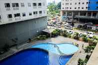 Lobby Comfort 2BR with Pool View Green Pramuka City Apartment by Travelio