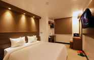 Kamar Tidur 6 Clover Hotel City Center Plus