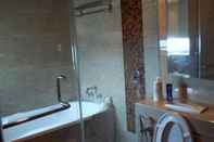 In-room Bathroom Strategic Room at The Windsor Apartment Near Lippo Puri and Puri Indah Mall