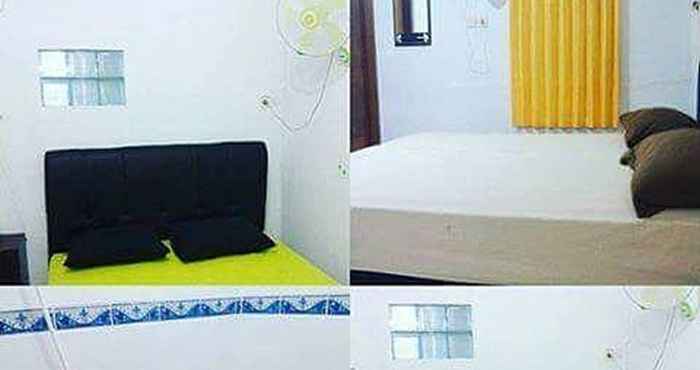 Kamar Tidur Red Palm Losmen Syariah