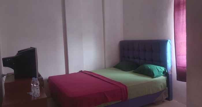 ห้องนอน OYO 90897 Hotel Sepupu Satria