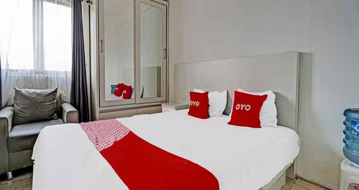 Kamar Tidur OYO 91880 The Suites Metro