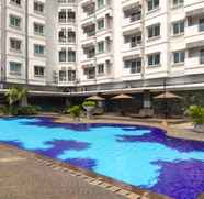 Swimming Pool 3 Cozy and Spacious 3BR at Poins Square Apartment By Travelio