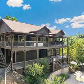 Hotel Exterior 1 Scenic Views and Hot Tub on Covered Deck - Charming Log Cabin, The Island in Pigeon Forge Hotels