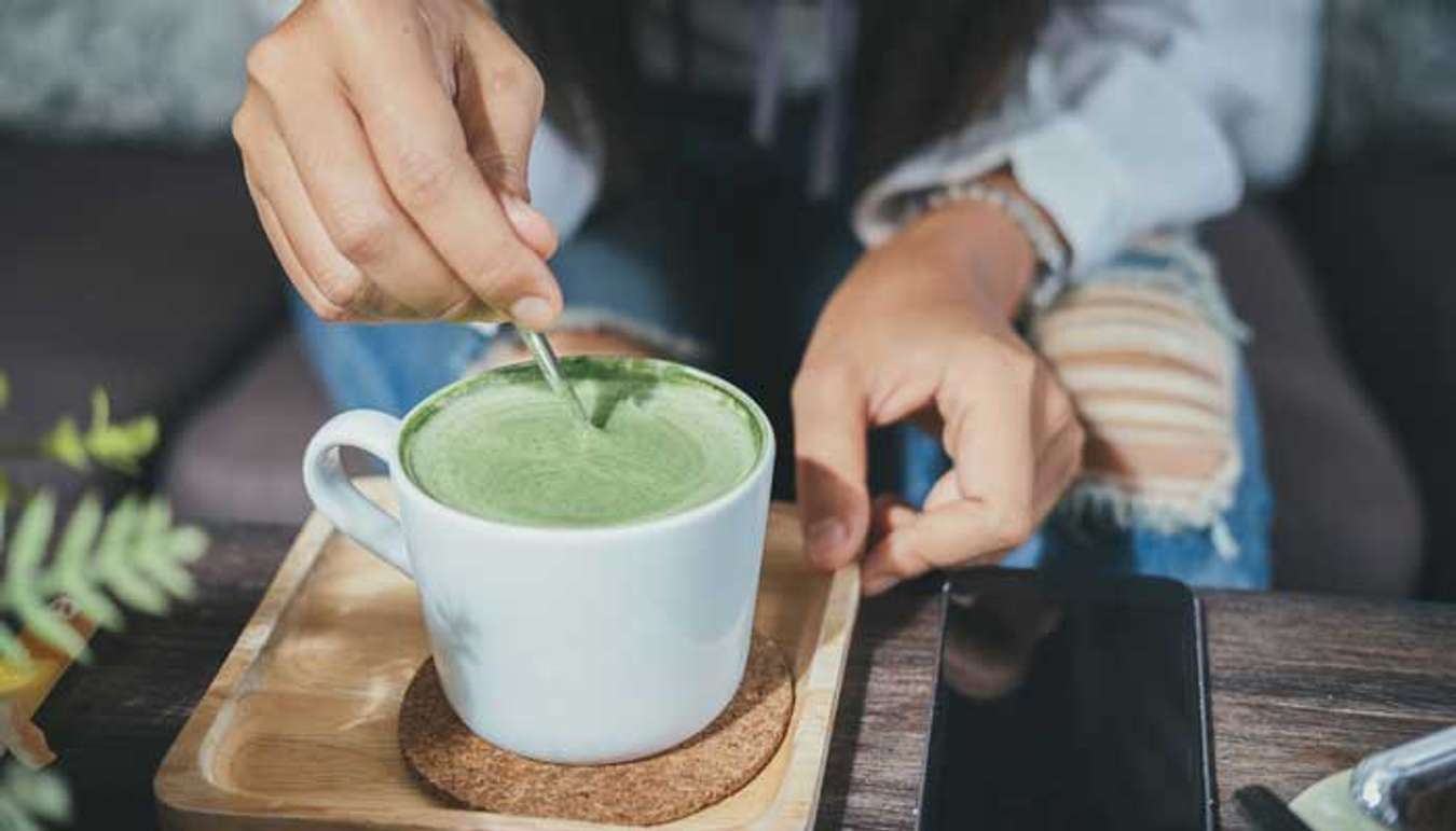 Girl mixing a matcha latte