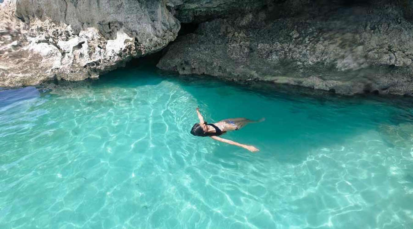 Person swimming in Locso-on cave pool