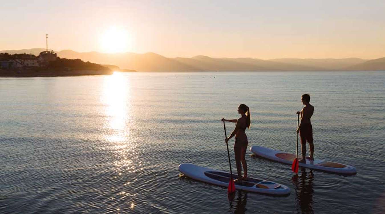 Couple paddle boarding