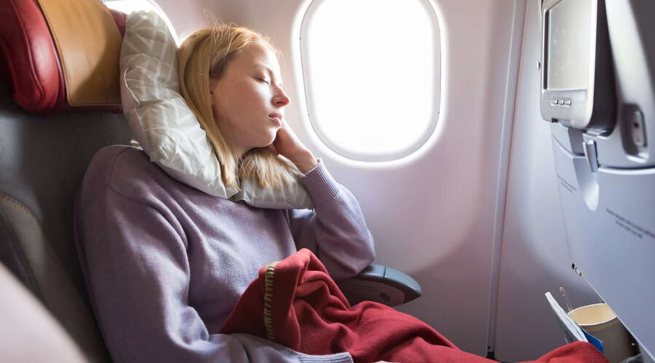 Female Traveler Sleeping In Long Flights