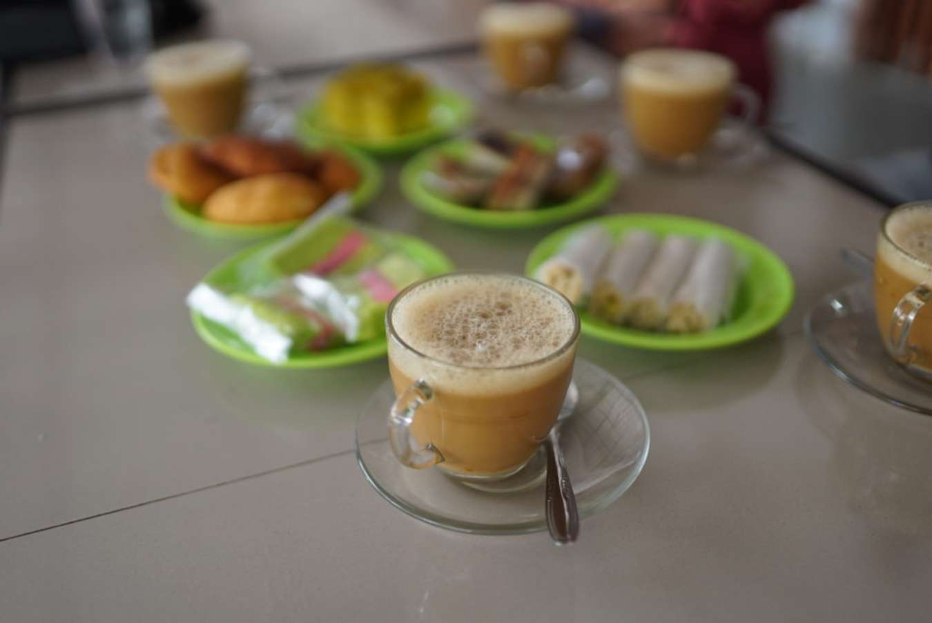 A close up of Banda Aceh local coffee on a table with local eateries in the background