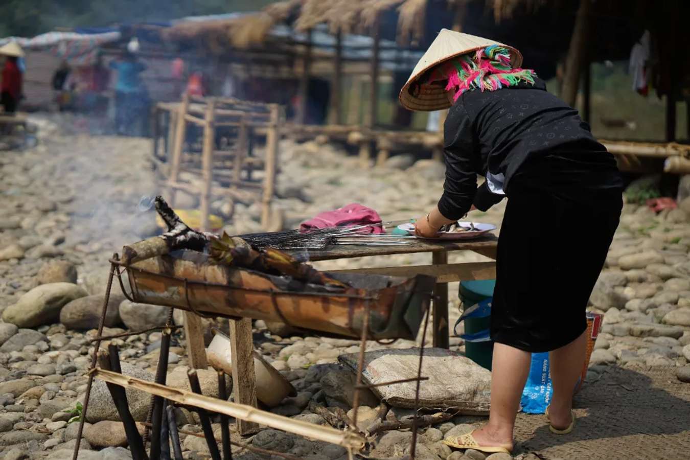 People are grilling fish.