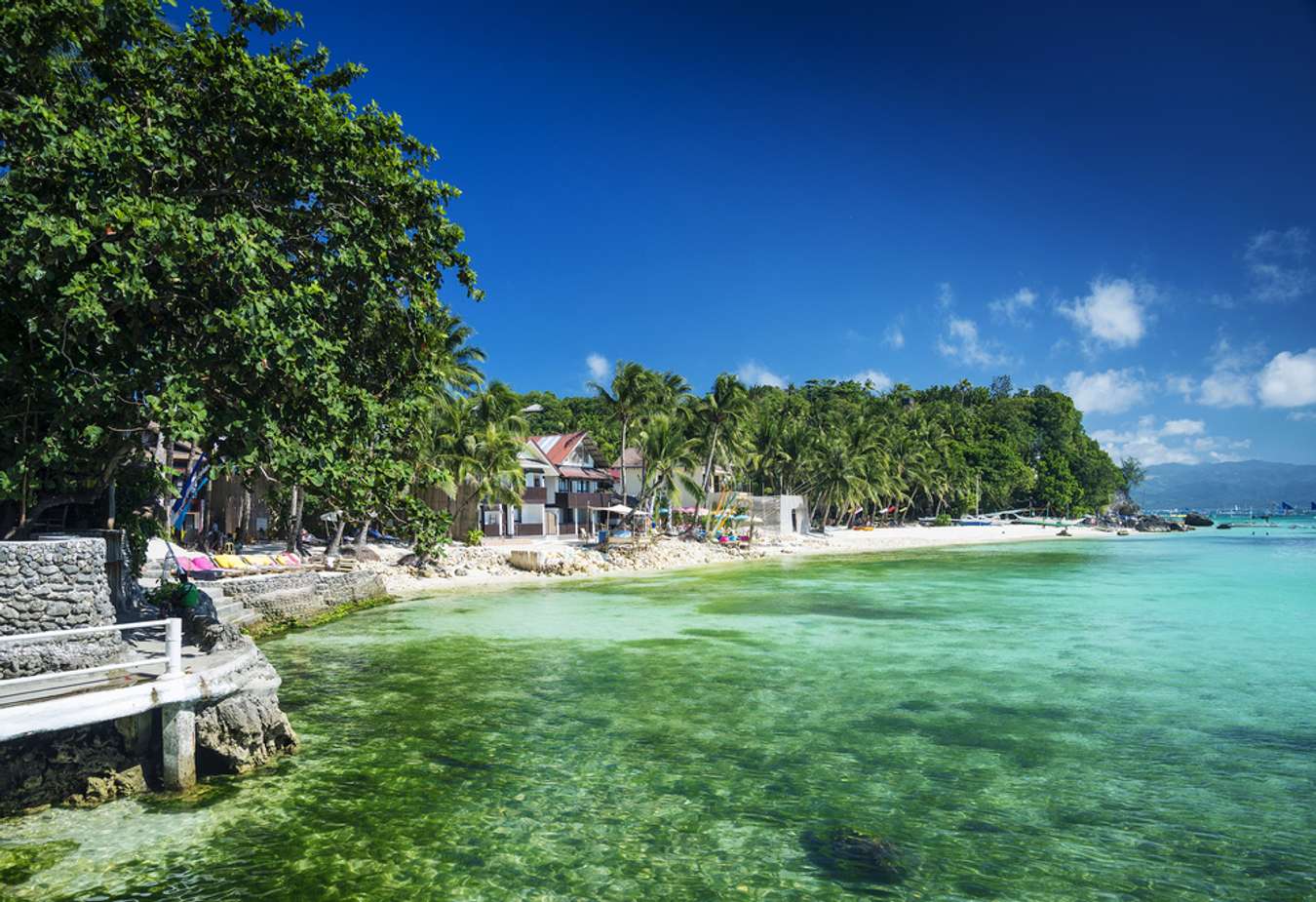 Crystal clear sea water bay. Pristine ocean lagoon sunny cloudy