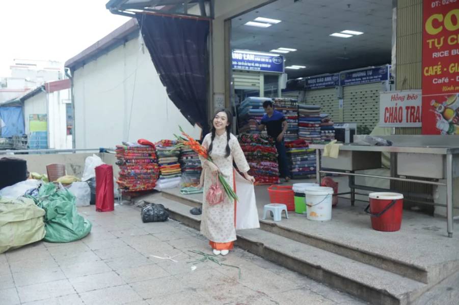 Tạo dáng bên gian hàng vải.