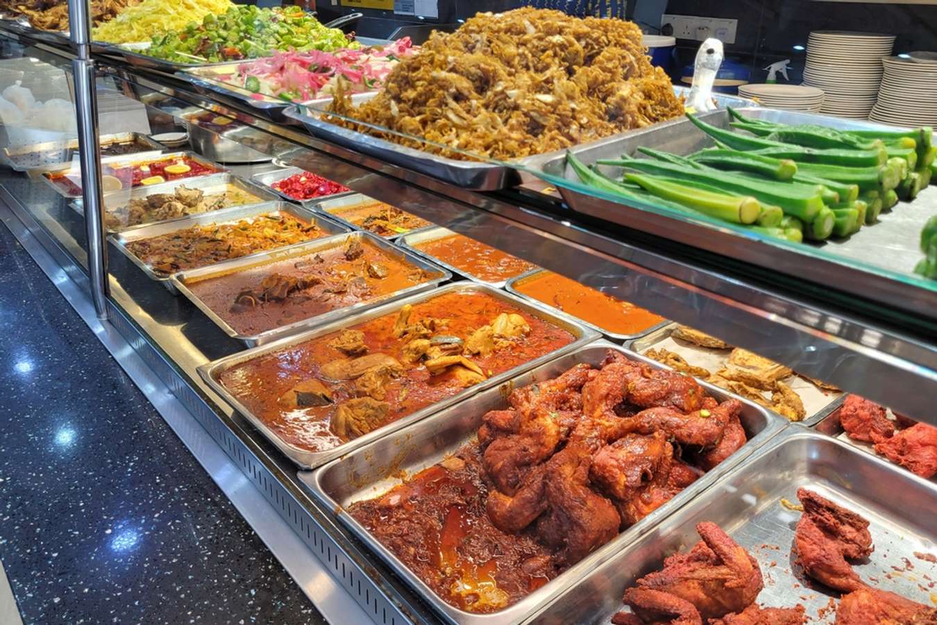 Variety of spicy curry dishes also known as 'Nasi Kandar' display