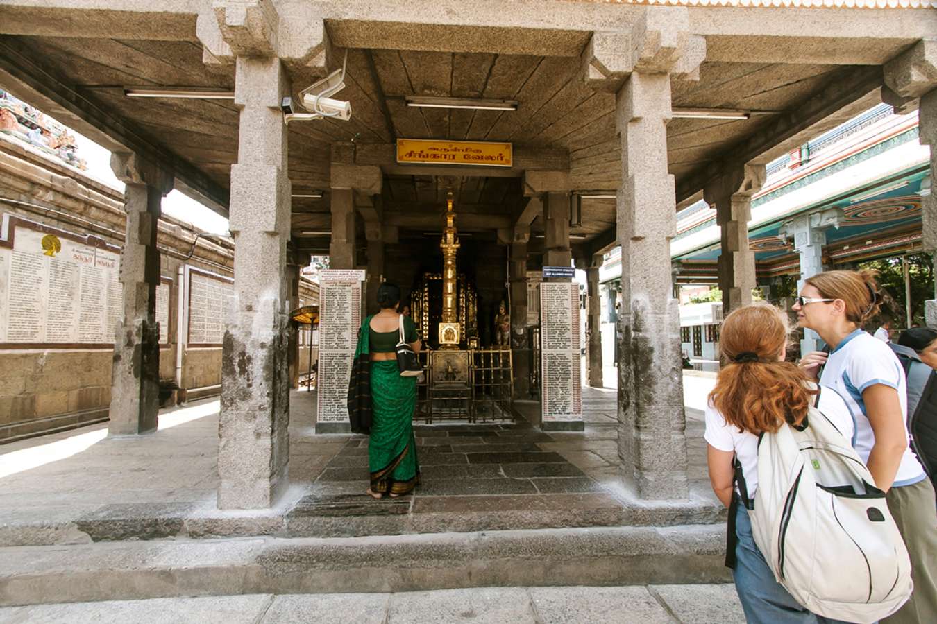  inside ARULMIGU KAPALEESWAAR temple complex here is another temple, two devotees and two visitors from abroad are here to pay a visit. Mylapore Chennai India