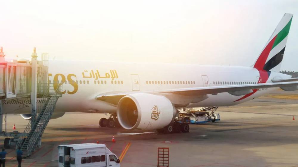 An Emirates plane at an airport.