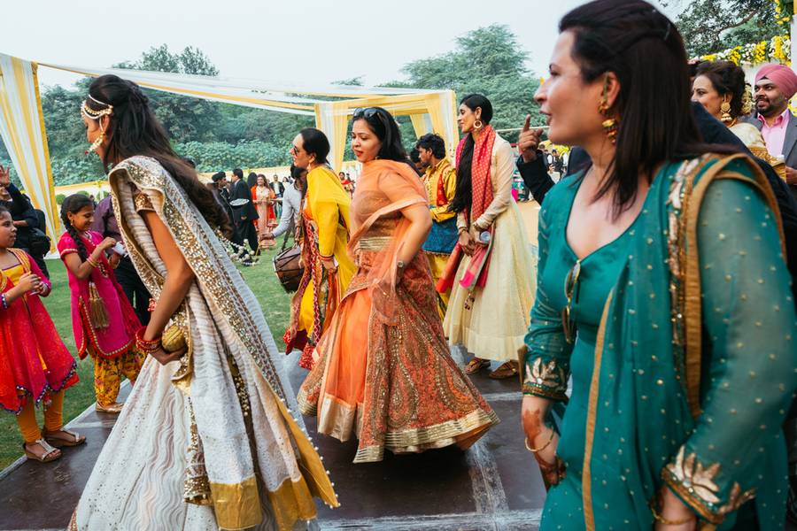 Guests dancing on the indian wedding banquet at night