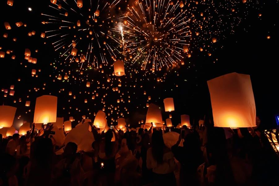 Tourists happily celebrate releasing lanterns at the Loi Krathong Yi Peng Lantern Festival according to Thai cultural traditions