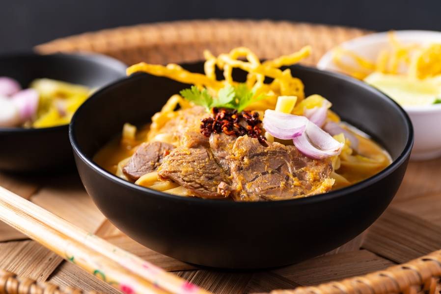 Northern Thai food (Khao Soi), Spicy curry noodles soup with coconut milk and beef, Local Thai food