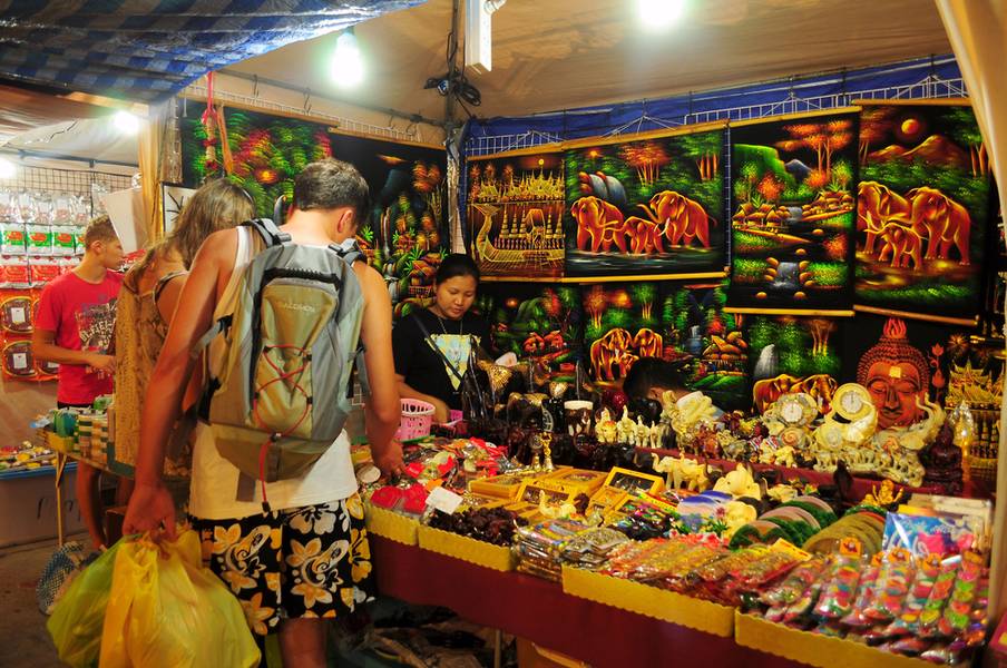 Pattaya, Thailand - Aug 24, 2014  - foreign tourist buys some Thai handicraft souvenirs at flea market in Pattaya