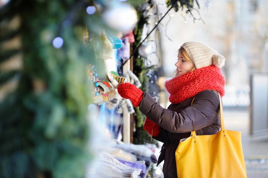 Outdoors portrait of young beautiful woman on a Christmas market