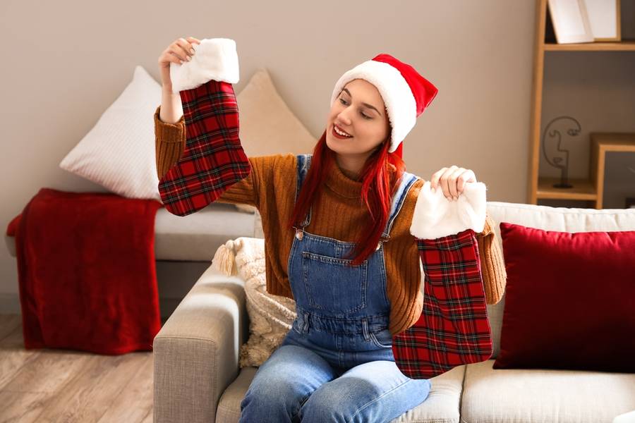 Young woman with Christmas socks at home