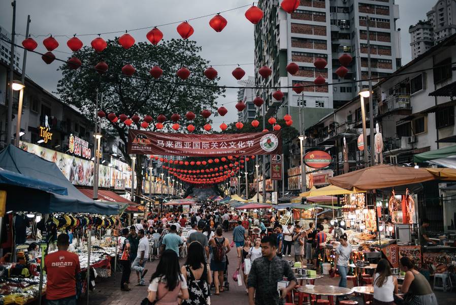 Kuala Lumpur, Malaysia - Nov 1, 2019 - Jalan Alor night market in the evening. The busy street is lined with food stalls and is adorn with red lanterns. 