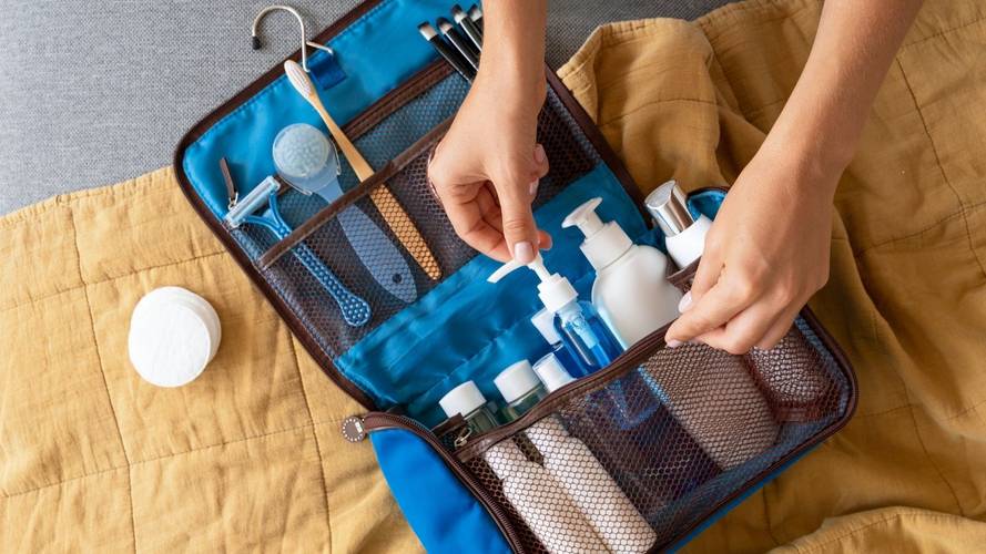 A woman packing toiletries that fit in a carry-on bag