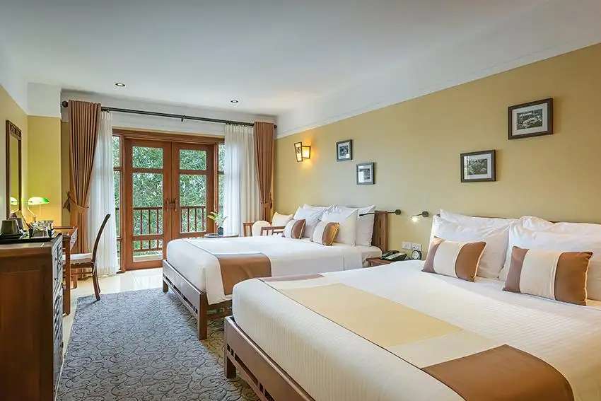 Phòng ngủ 2 giường đôi thoải mái tại Deluxe Family Classic Balcony tại La Siesta Hoi An Resort & Spa